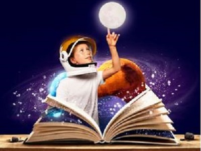 Child standing before desk with open book, in front of galaxies - from freepik